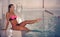 A female swimmer in indoor sport swimming pool. girl in pink sweimsuit training
