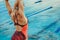 Female swimmer stretching body before swim