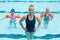 Female swimming trainer with girls in swimming pool