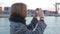 Female take photo of port infrastructure on deck of boat