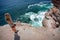 Female takes in the ocean views from cliff top ledge