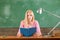 Female teacher in the classroom on the chalkboard. College girl in class.