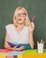 Female teacher in the classroom on the chalkboard. College girl in class. Serious idea.