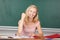 Female Teacher With Clenched Fist At Desk