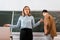 Female teacher gesturing in classroom