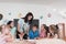 Female Teacher with kids in biology class at elementary school conducting biology or botanical scientific experiment