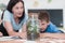 Female Teacher with kids in biology class at elementary school conducting biology or botanical scientific experiment