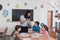 Female Teacher with kids in biology class at elementary school conducting biology or botanical scientific experiment