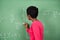 Female Teacher Solving Mathematics On Board