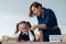 A female teacher yells at a student. Little girl covers her ears with her hands.