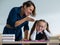 A female teacher yells at a student. Little girl covers her ears with her hands.