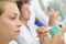 Female technician shaping dental impressions