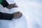 Female teen hands in mittens grabbing fresh snow