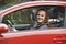 Female Teenage Driver Looking Out Of Car Window