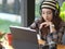 Female teenager with headphone relaxing with digital tablet  in cafe