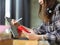 Female teenager with headphone using digital tablets and smartphone in cafe