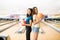 Female Teenagers Holding Bowling Balls In Club