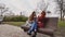 Female teenagers listening to music on smartphone sitting on the bench