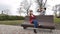 Female teenagers listening to music on smartphone sitting on the bench