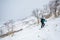 Female telemark skier hiking uphill to ski the backcountry powder snow of Hokkaido near Niseko Mountian