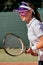 Female tennis player playing game on outdoor court. Athlete caucasian woman with racket