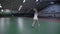 Female tennis player playing on indoor court against male player