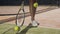 Female tennis player spining racket on the ground and throwing tennis ball.