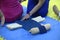 Female therapist hands help a woman to lay on acupressure mat
