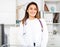 Female therapist stands near the workplace in the resident's office