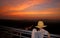 Female thinking something with the impressive evening sunset sky in backdrop