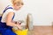 Female tiler tiling tiles on the floor