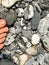 Female toes and rocks and pebbles on the banks of a river