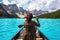 Female Tourist Canoeing on Moraine Lake in Banff National Park, Canadian Rockies, Alberta, Canada