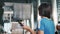 Female tourist checking boarding electronic schedule information at arrival departure board