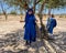 Female tourist dressed in Arabic garb, ready for a camel ride in Marrakesh.