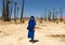 Female tourist dressed in Arabic garb, ready for a camel ride in Marrakesh.