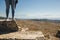 Female tourist feet in ancient ruins. Panoramic view in mountains. Copy space. Tourism concept