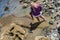 Female tourist finds interesting sea life washed up on the beaches at Point Cabrillo National Monument during low tide in