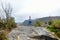 Female tourist hiking on cliff-top promontory above a bend of the Tskhaltsitela River