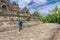 female tourist jumping and smiling while visiting Borobudur temple