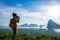 Female tourist photographers travel on the mountain. Landscape Beautiful Mountain on sea at Samet Nangshe Viewpoint. Phang Nga Bay