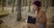 Female tourist reading diary in forest