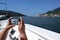 Female tourist on the ship takes mobile phone photos of the coast at Porto Venere; gulf of La Specia; Liguria; Italy, copy space