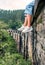 Female tourist sits on the Demodara nine arches bridge in Ella,