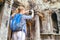 Female tourist with smartphone taking picture in Angkor Wat