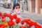 Female Tourist smiling and looking at camera against of tulip flowers in Porto, Portugal