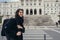 Female tourist standing in front of the Parliament of Portugal, Assembly of the Republic