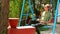 Female tourist on swing drinking coffee