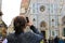 Female tourist taking phot by smartphone of Florence Cathedral in Italy.