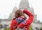 Female tourist taking photo of Sacre-Coeur cathedral